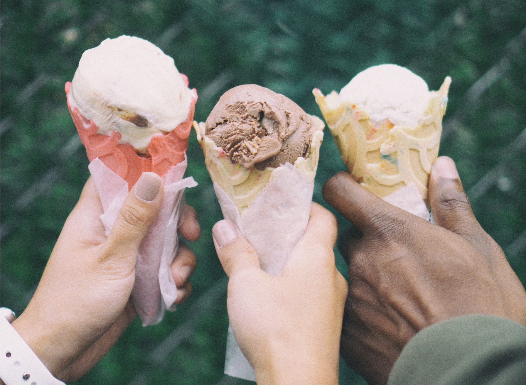 Three friends holding ice cream cones