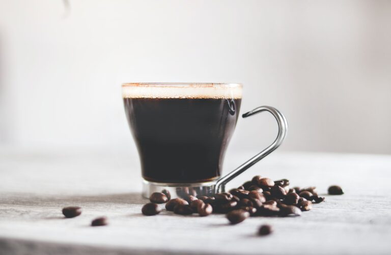 A cup of coffee and coffee beans